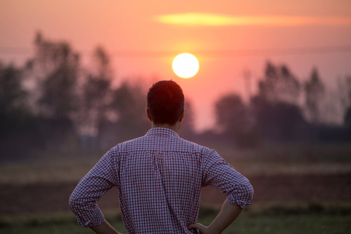 Man looks at sunrise